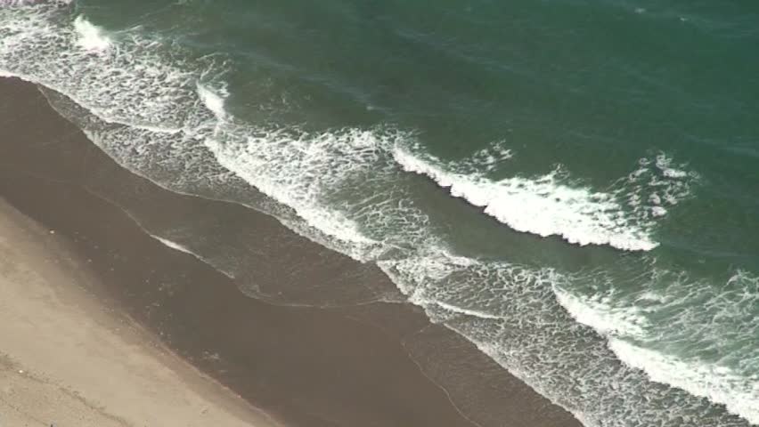Aerial view of deserted beach in Gibraltar with seagulls