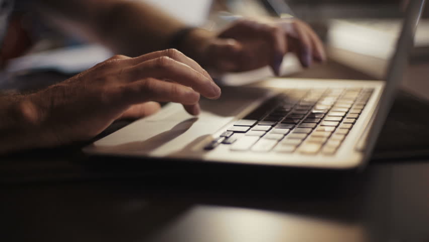 A man with glasses uses a computer. Something is looking for. Enthusiastic. Works in a modern office. Shot on RED Epic Camera. Royalty-Free Stock Footage #31328356