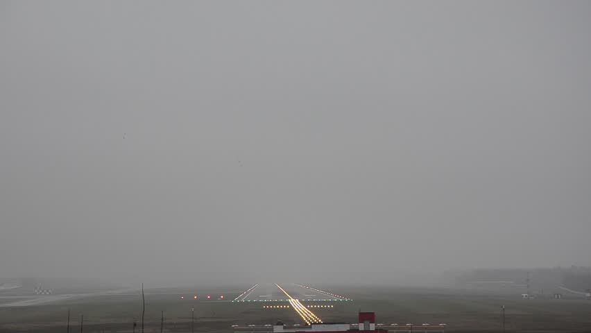 The plane lands in fog, in bad weather