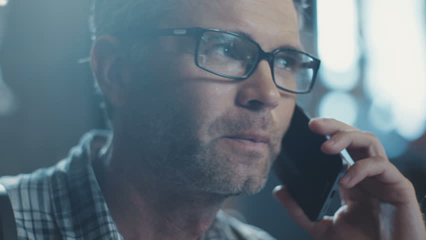 The man in his glasses speaks on the phone fluttering the book interior design. Something is looking for. Design Business. Enthusiastic. Design, abstract. Shot on RED Epic Camera. Royalty-Free Stock Footage #31330261