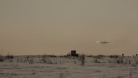 airplane on the runway, the plane is landing, snow-covered runway, small passenger plane,  Russia