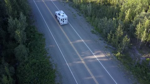 Aerial follow shot of RV in the mountains on the Alaska Highway in Yukon
