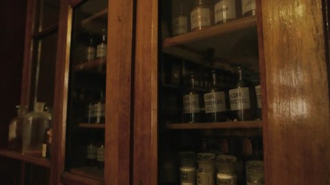 Vintage drugstore shelves. Old pharmaceutical bottles with labels. First medicine breakthroughs.