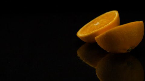 Orange rolls out on a black table