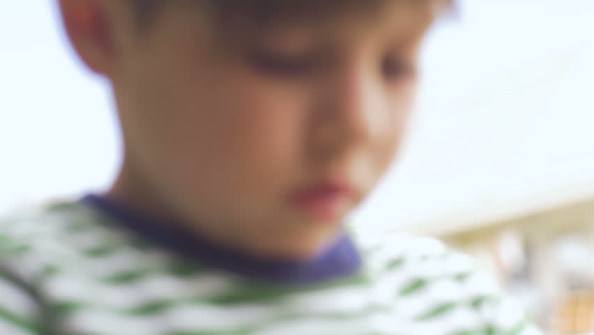 Close up of a cute boy learning and asking questions in slow motion