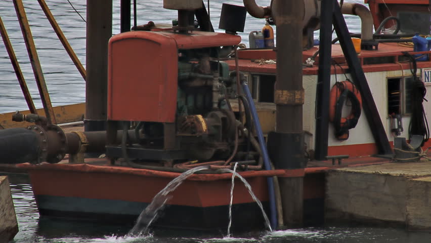 HOMER, AK - CIRCA 2012: Close-up of a small dredging rig at work in the harbor.
