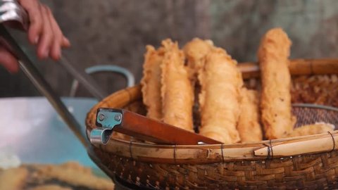 Taking Out Deep Fried Food From Oil And Into Basket - Slide Right And Left - Close Up
