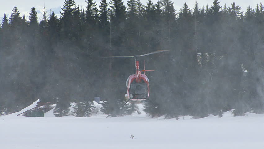 HOMER, AK - CIRCA 2012: Red 2-man helicopter (Robinson R22) takes off and hovers