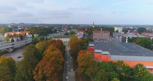 Aerial footage of foliage in small Estonian town. Autumn aerial flyover of scenic alley in town.