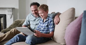 Father and Son looking at a digital tablet