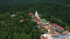 Moving to temple and statue buddha on the mountain and forest around on top view or bird view