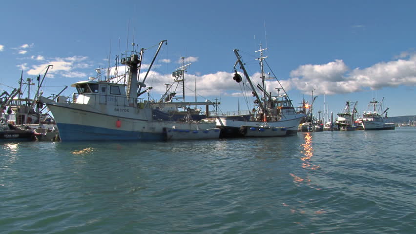 HOMER, AK - CIRCA 2012: Passing a row of fishing boats into the main channel of