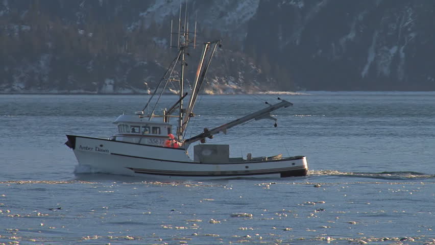 HOMER, AK - CIRCA 2012: Slanting sunlight illuminates an Alaskan fishing trawler