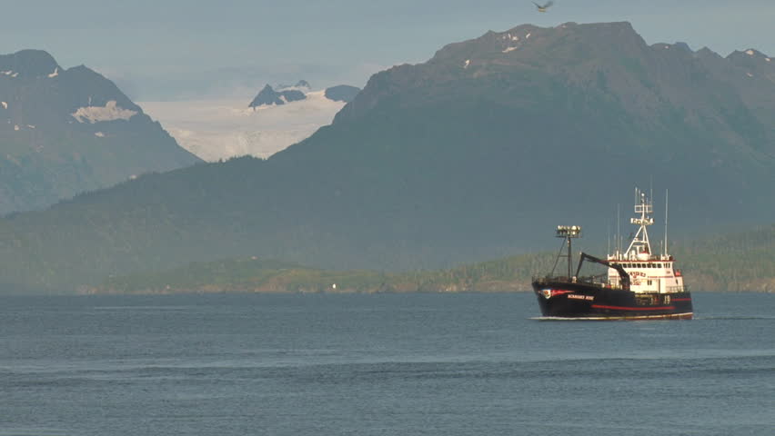 HOMER, AK - CIRCA 2012: Late afternoon, late summer, a crab fishing boat heads