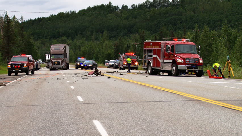 SUTTON, AK - CIRCA 2012: Accident scene with emergency personnel investigating