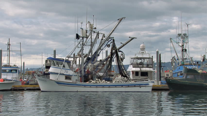 HOMER, AK - CIRCA 2012: Tending nets on a fishing boat in the harbor before