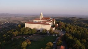 Aerial view of the Arch-monastery of Pannonhalma in sunrise, Hungary - drone video