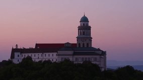 Aerial view of the Arch-monastery of Pannonhalma in sunrise, Hungary - drone video