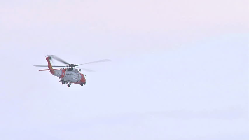 HOMER, AK - CIRCA 2012: Coast Guard helicopter flies off to rescue someone from