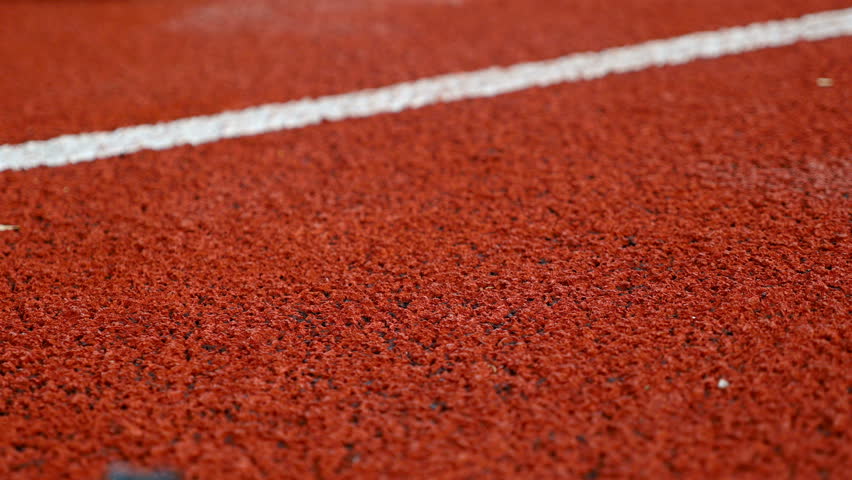 Close detail of track runner woman putting hands at starting line