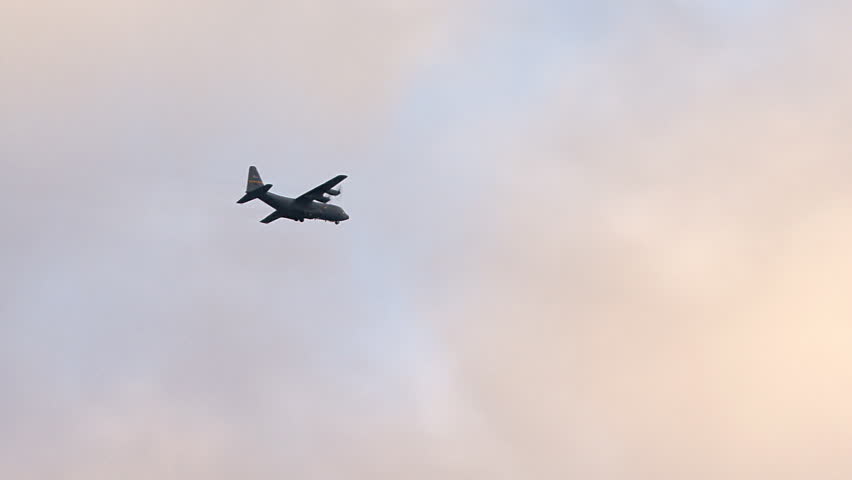 HOMER, AK - CIRCA 2012: HC130 making a low banking turn on approach with evening