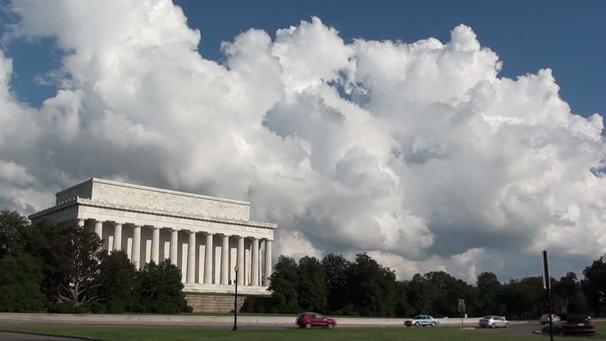 The Lincoln Memorial, rear side facing Memorial Bridge, with car traffic and pretty clouds.  Early afternoon rush hour traffic headed to Memorial Bridge and Northern Virginia.