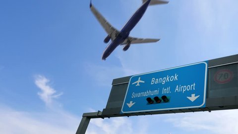 airplane flying over bangkok airport signboard