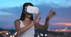 Woman watching with VR device in the evening 