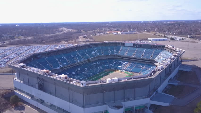CIRCA 2010s - Detroit, Michigan - Aerial over the abandoned and incredibly spooky Pontiac Silverdome football stadium near Detroit Michigan.