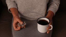 Woman holds a cup of coffee and spins fidget spinner