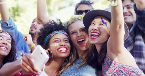 Portrait of Caucasian, Asian and mixed race female friends having fun at music festival 4k