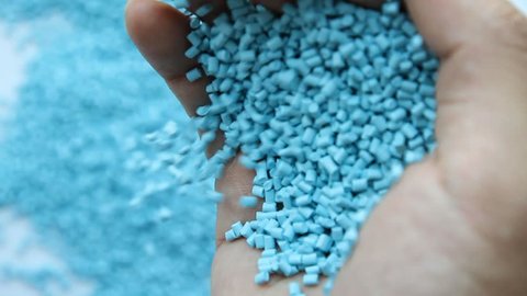hands and raw material of plastic or masterbatch for plastic molded in injection factory.