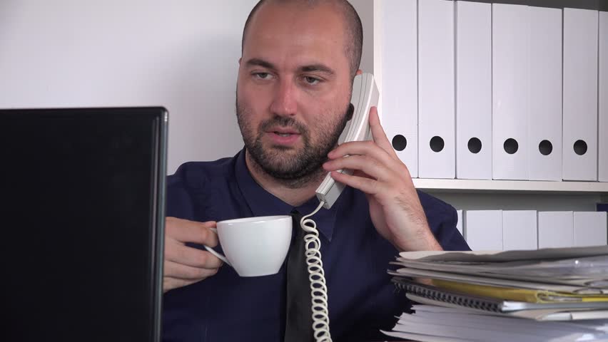 Inside office work close-up busy business man drinking coffee landline discuss