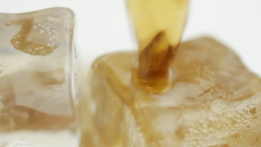 Pouring cola over ice CU Rotation