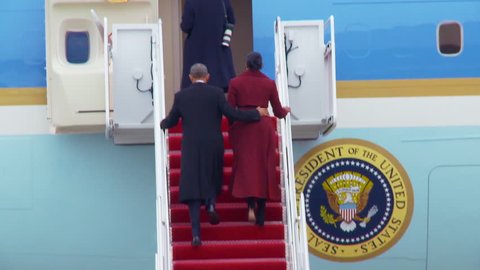 CIRCA 2010s - President Barack Obama and Michelle Obama departing Joint Base Andrews and boarding Air Force One at the end of the Presidential term.