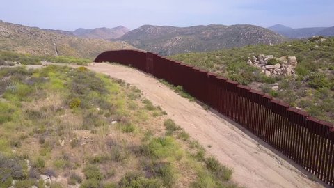 CIRCA 2010s - U.S.-Mexico border - A low aerial along the U.S Mexican border wall fence.
