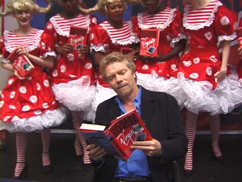 NEW YORK, USA – CIRCA 1998: Billionaire Richard Branson presents and signs the first edition of his autobiography  book 'How I Lost My Virginity', New York, USA circa 1998
