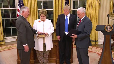 CIRCA 2010s - Vice President Mike Pence swears in Secretary Of State Rex Tillerson with President Donald Trump looking on.