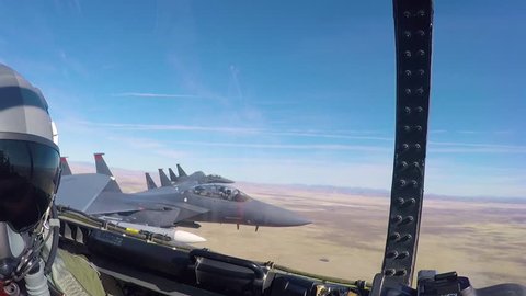 CIRCA 2010s - POV from inside of a fighter jet as it flies in formation.