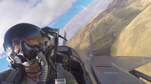 CIRCA 2010s - POV from inside of a fighter jet as it flies in formation.