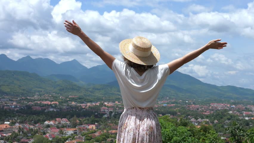 Girl With Arms Wide Open On Top Of Mountain Watching Beautiful Scenery. Slow Motion. HD, 1920x1080. 