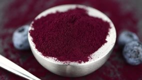 Blueberry powder on a rotating plate as 4K UHD footage (seamless loopable)