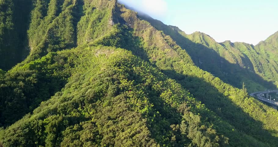 Amazing aerial footage view of the mountains by the famous Haiku stairs and stairs to Heaven hike. The living district next to the trail. Amazing Hawaii.
