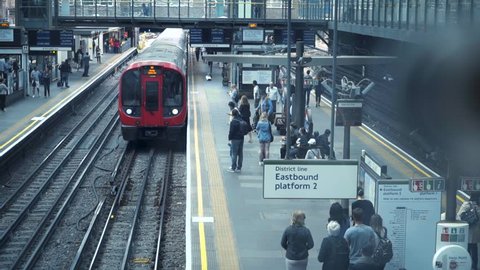 EARLS COURT STATION, LONDON - JULY 20, 2016: Train arrives the subway station. People getting off and on the tube. Rush hour