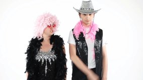 Young dancing couple in sparkling dress and hat. Let's celebrate the victory! HAving fun party mood people. White background video footage