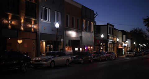 A nighttime establishing shot of businesses on a typical Main Street in America. Pittsburgh suburb. Day Night matching available.