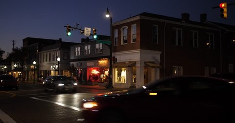 A nighttime establishing shot of businesses on a typical Main Street in America. Pittsburgh suburb.	Building names and addresses obscured.  Day Night matching available. Day ID: 20833027