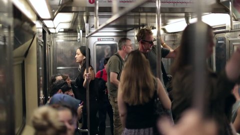 NEW YORK CITY, USA - September 20, 2017- Slow-motion shot of people standing inside subway wagon moving underground in new york city. tourists standing on subway wagon