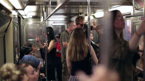 NEW YORK CITY, USA - September 20, 2017- Slow-motion shot of people standing inside subway wagon moving underground in new york city. Commuters inside train wagon