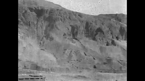 CIRCA 1920s - Egyptians excavate mortuary tombs at an archeological site in the cliffs of Deir el Bahri, in the Valley of the Nile, in Egypt, in 1920.
